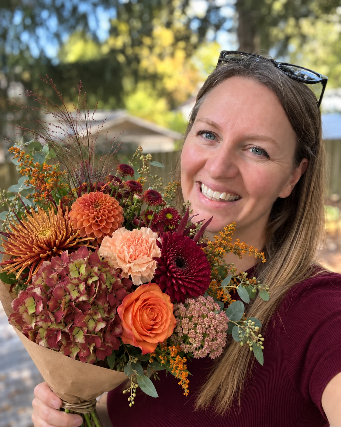 Thanksgiving bouquet of dahlias, roses and seasonal blooms in orange, peach and burgundy